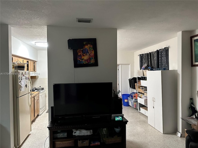 1838 NW 18th St, Miami, FL 33125 - living room featuring a textured ceiling and dark aggregate flooring