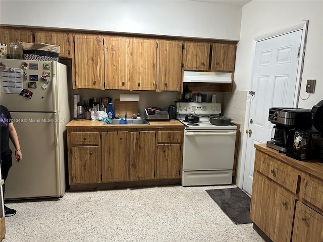 1838 NW 18th St, Miami, FL 33125 - kitchen featuring white appliances, range hood, brown cabinets, and light countertops
