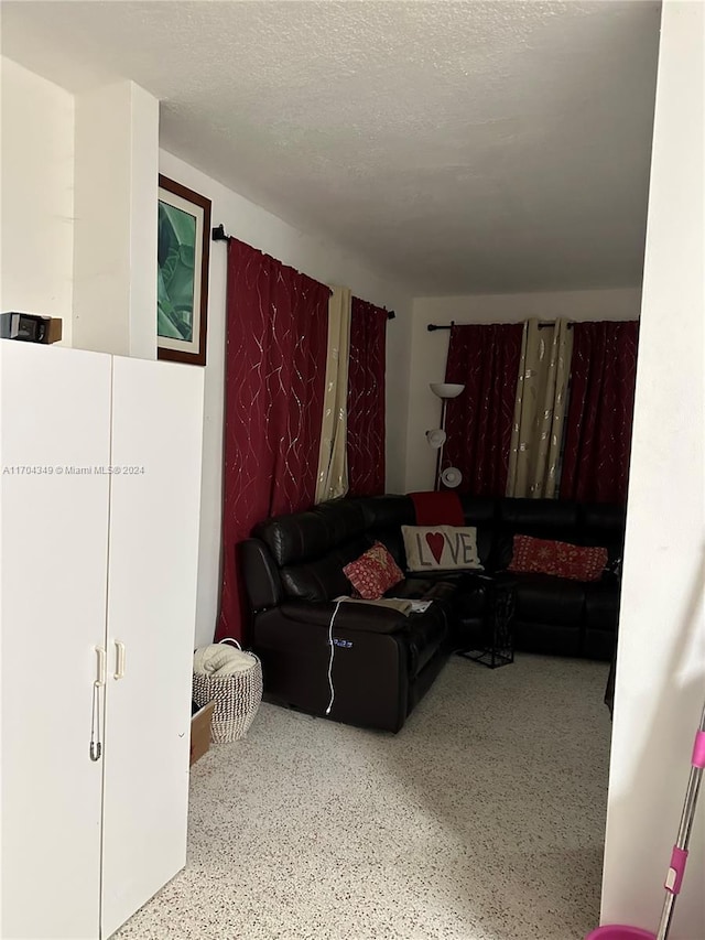 1838 NW 18th St, Miami, FL 33125 - living room featuring speckle patterned floor and a textured ceiling