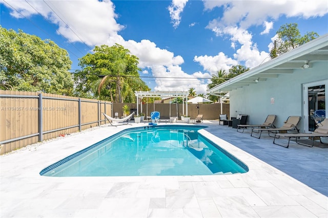 view of swimming pool featuring a pergola and a patio area