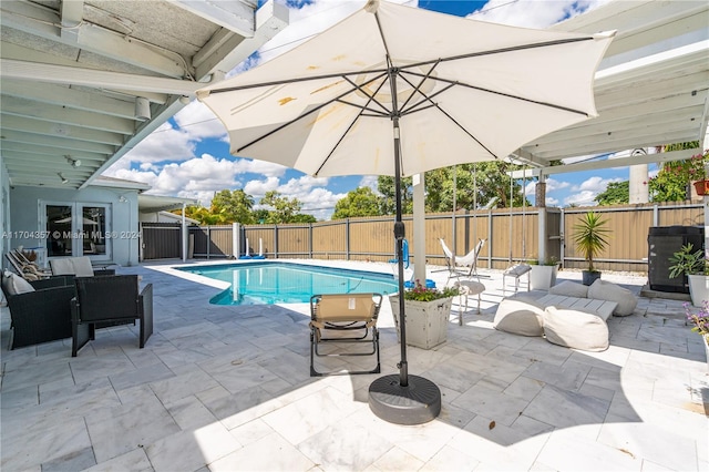 view of swimming pool featuring french doors and a patio