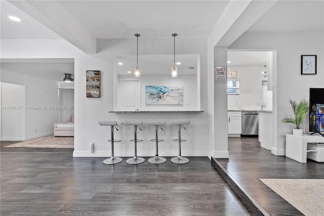 kitchen featuring a breakfast bar, decorative light fixtures, dishwasher, white cabinets, and dark hardwood / wood-style floors