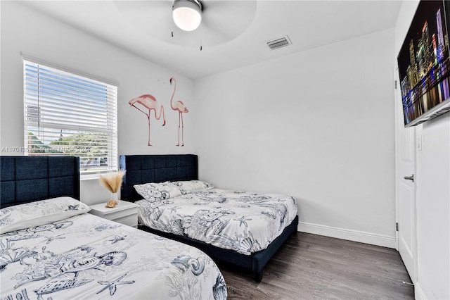 bedroom featuring ceiling fan and dark wood-type flooring