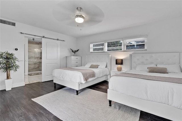 bedroom featuring ceiling fan, dark hardwood / wood-style floors, and connected bathroom