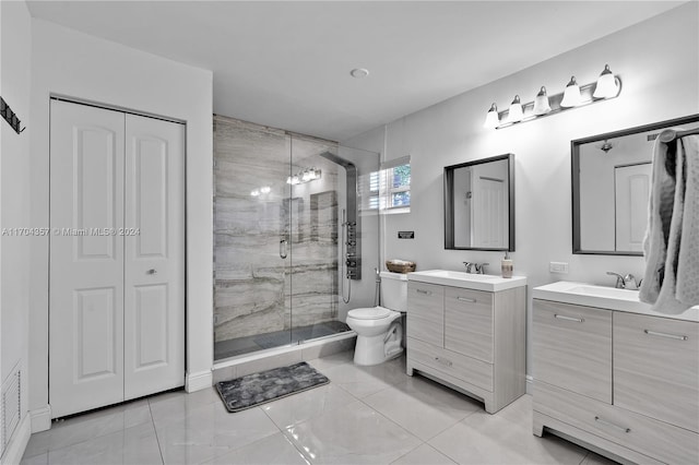 bathroom with vanity, toilet, and a shower with shower door