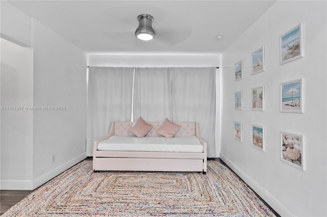 sitting room featuring ceiling fan and wood-type flooring