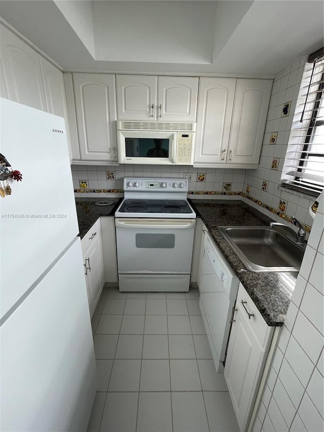 kitchen featuring backsplash, white cabinetry, white appliances, and sink