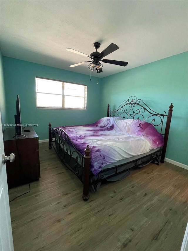 bedroom with hardwood / wood-style floors and ceiling fan