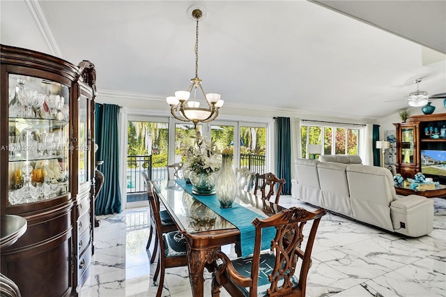 dining area featuring ceiling fan with notable chandelier and crown molding