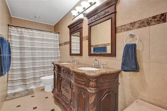 bathroom featuring curtained shower, vanity, and tile walls