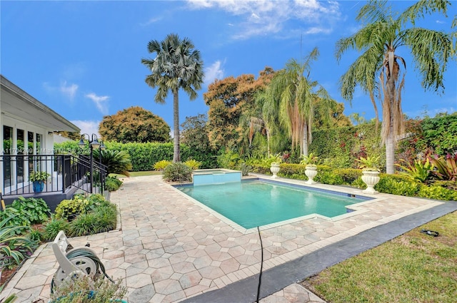 view of swimming pool featuring a patio and an in ground hot tub