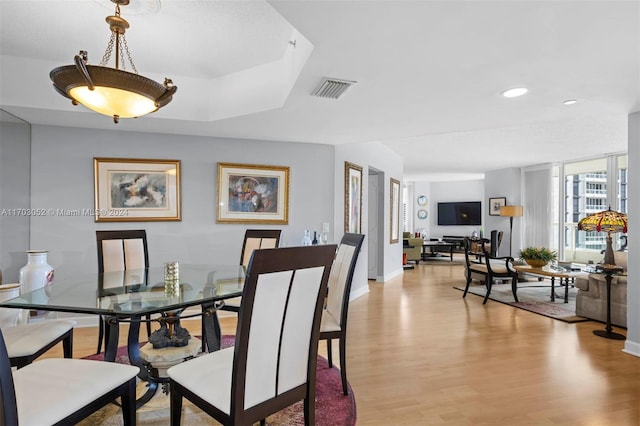 dining space with light hardwood / wood-style floors