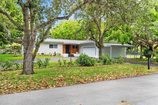 ranch-style house with a garage and a front yard