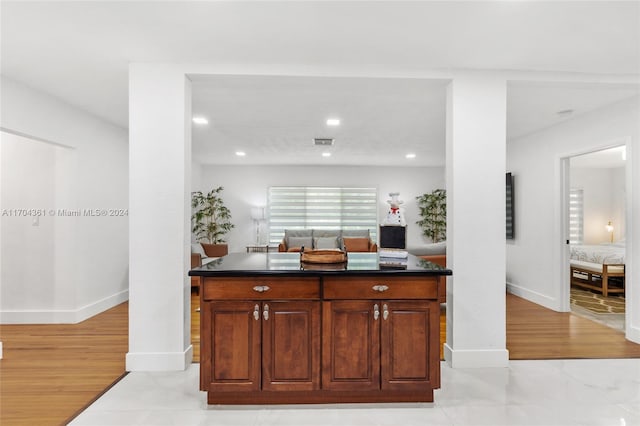 kitchen featuring a kitchen island and light hardwood / wood-style floors