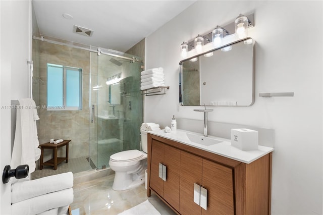 bathroom with tile patterned floors, vanity, toilet, and a shower with shower door