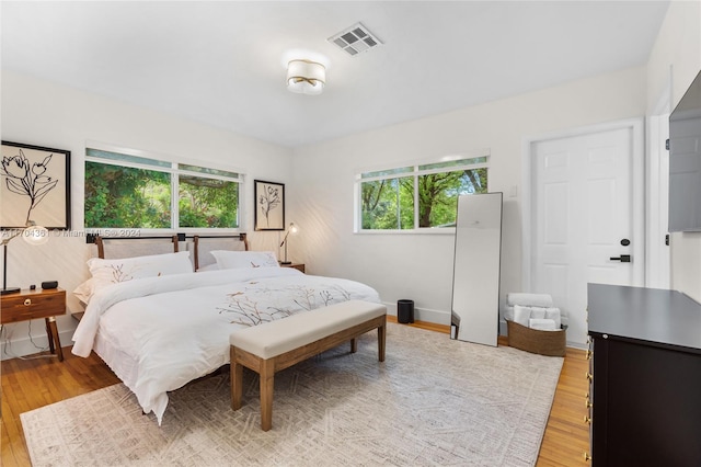 bedroom featuring light wood-type flooring and multiple windows