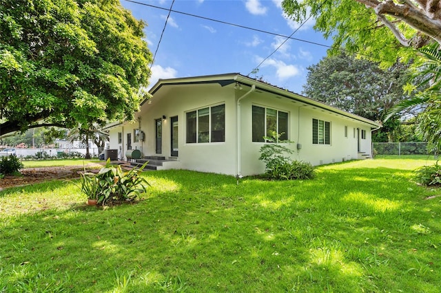 view of side of property with a yard