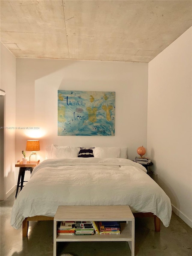 bedroom featuring concrete floors