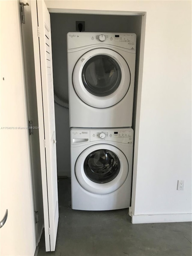 clothes washing area with stacked washer and clothes dryer