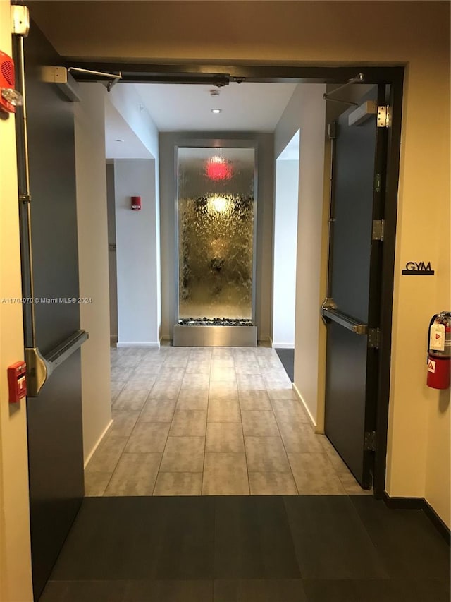 corridor featuring light tile patterned flooring