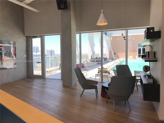 dining area featuring hardwood / wood-style floors and a high ceiling