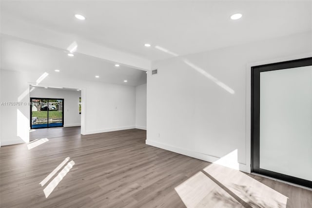 unfurnished living room featuring hardwood / wood-style floors