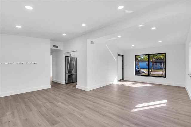 unfurnished living room with light hardwood / wood-style floors