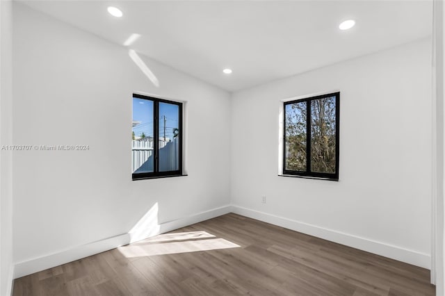 unfurnished room with hardwood / wood-style floors