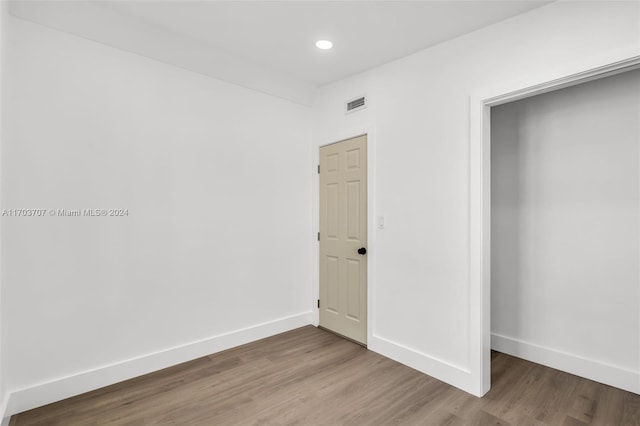 unfurnished bedroom with wood-type flooring and a closet