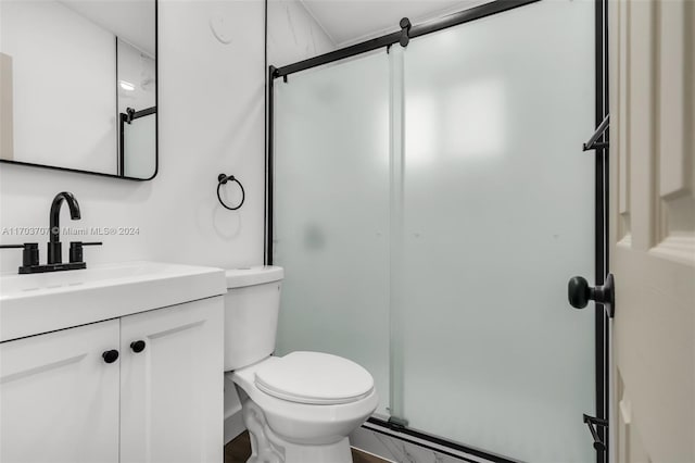 bathroom with vanity, toilet, and walk in shower