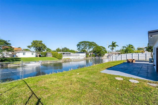 view of yard with a patio area and a water view