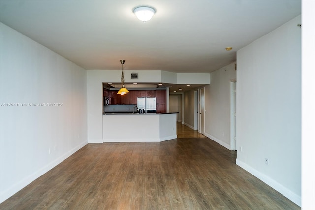 unfurnished living room featuring dark hardwood / wood-style flooring and sink