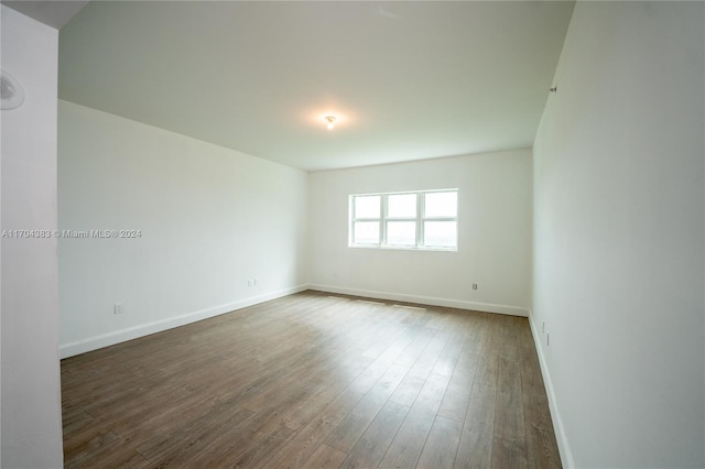 empty room featuring dark hardwood / wood-style flooring