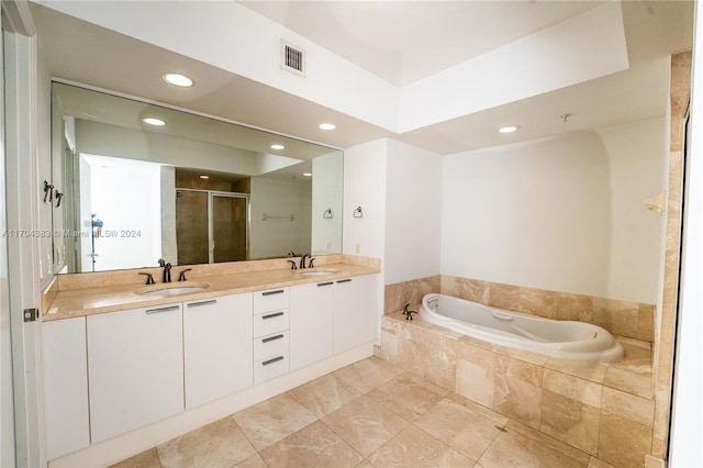 bathroom featuring vanity and shower with separate bathtub