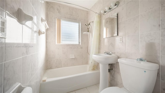 bathroom with tile patterned floors, shower / bath combination with curtain, toilet, and tile walls