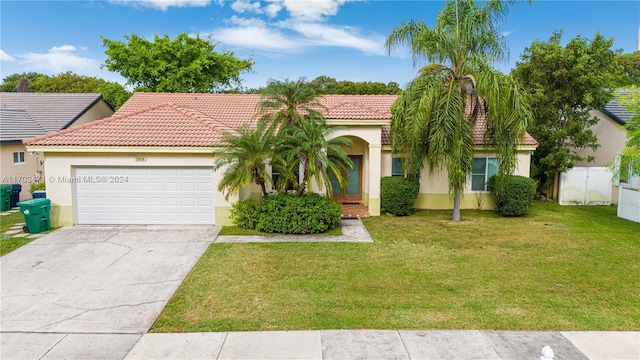 mediterranean / spanish home with a front yard and a garage