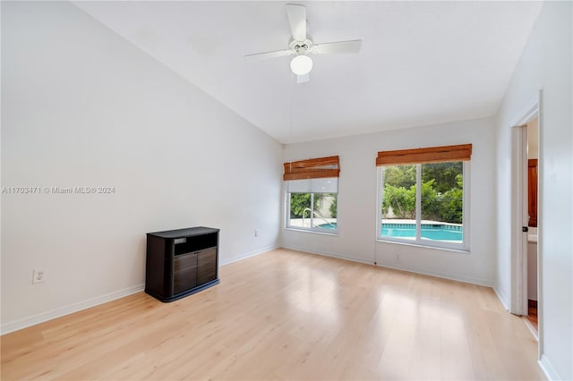 unfurnished living room with ceiling fan, light hardwood / wood-style floors, and vaulted ceiling