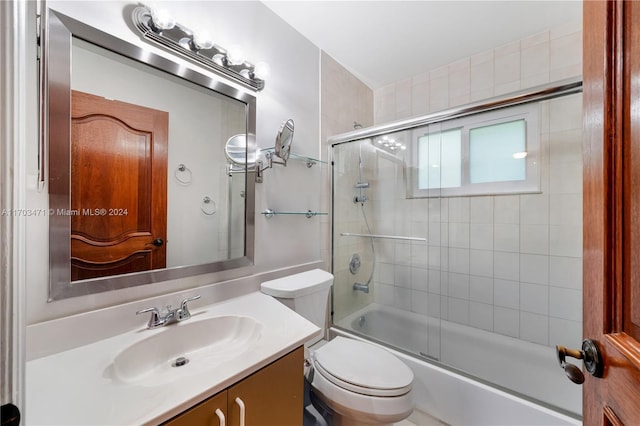 full bathroom with vanity, toilet, and bath / shower combo with glass door