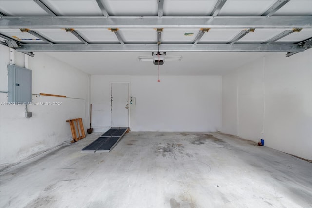 garage featuring a garage door opener and electric panel