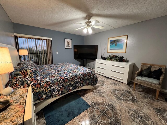 tiled bedroom featuring ceiling fan and a textured ceiling