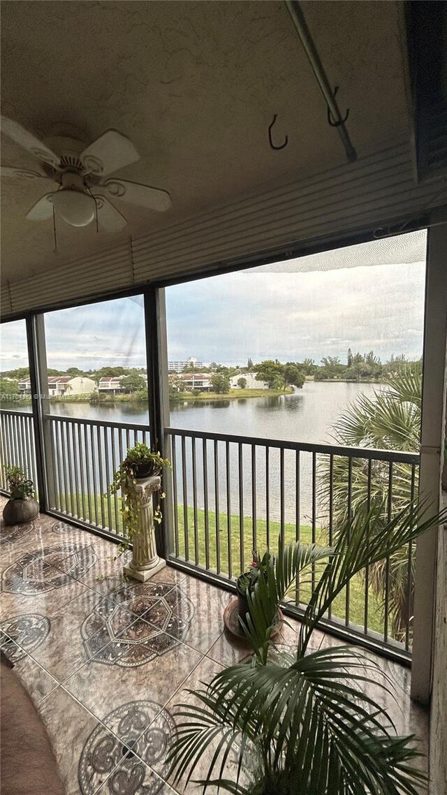 exterior space featuring a water view and ceiling fan