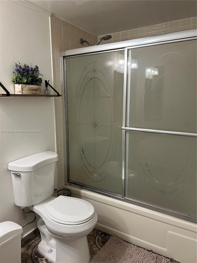 bathroom with toilet and enclosed tub / shower combo