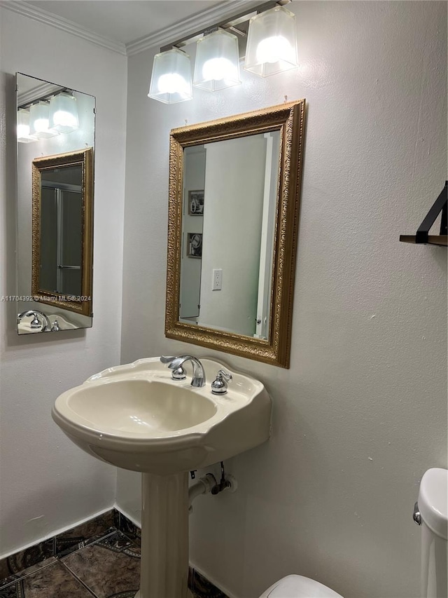 bathroom with toilet, tile patterned flooring, and ornamental molding