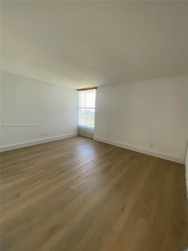 empty room with wood-type flooring