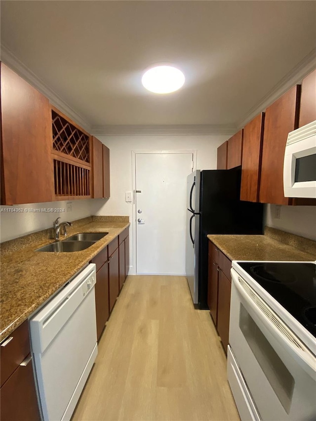 kitchen featuring sink, white appliances, and light wood-type flooring