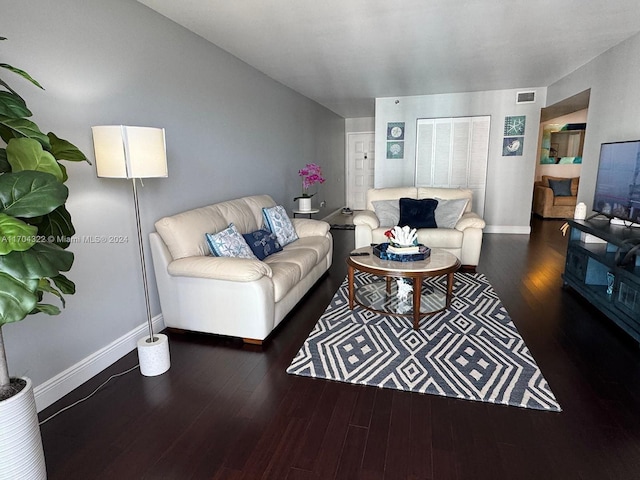 living room with dark hardwood / wood-style flooring