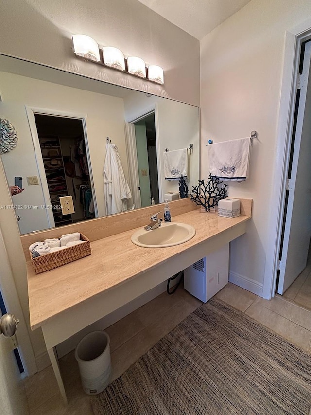 bathroom with tile patterned flooring and vanity