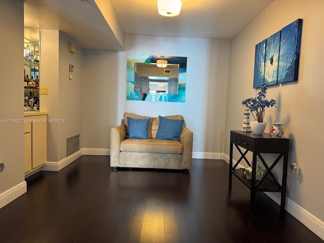 sitting room featuring dark wood-type flooring