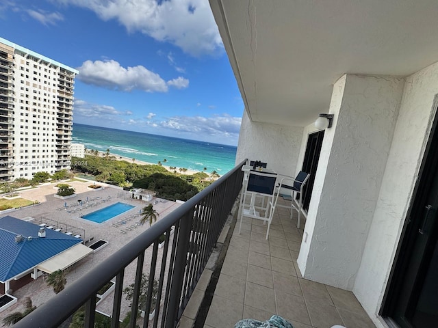 balcony featuring a water view and a beach view