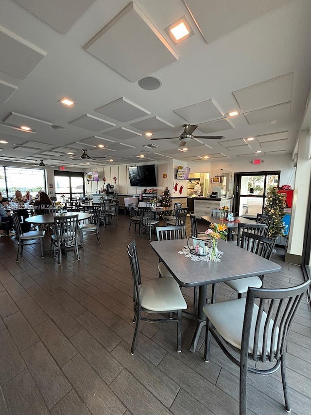 dining space featuring ceiling fan, wood-type flooring, and coffered ceiling